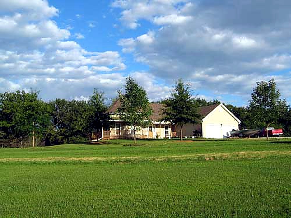Same home after Tree Patch planted mature shade trees in the front lawn