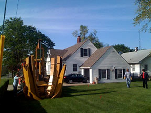Tree Patch spade truck on the lawn in front of a white home